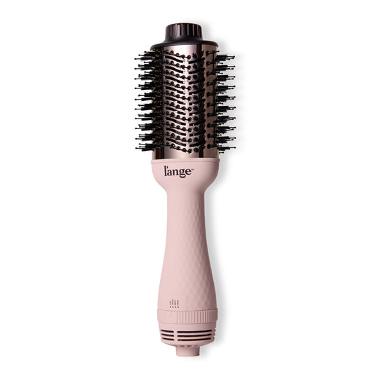 LĄŻange Le Volume in blush positioned at a horizontal angle, showcasing patent-pending barrel for added volume.